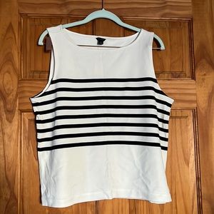 Sophisticated tank that is cream with black striped. Hits at the hips.